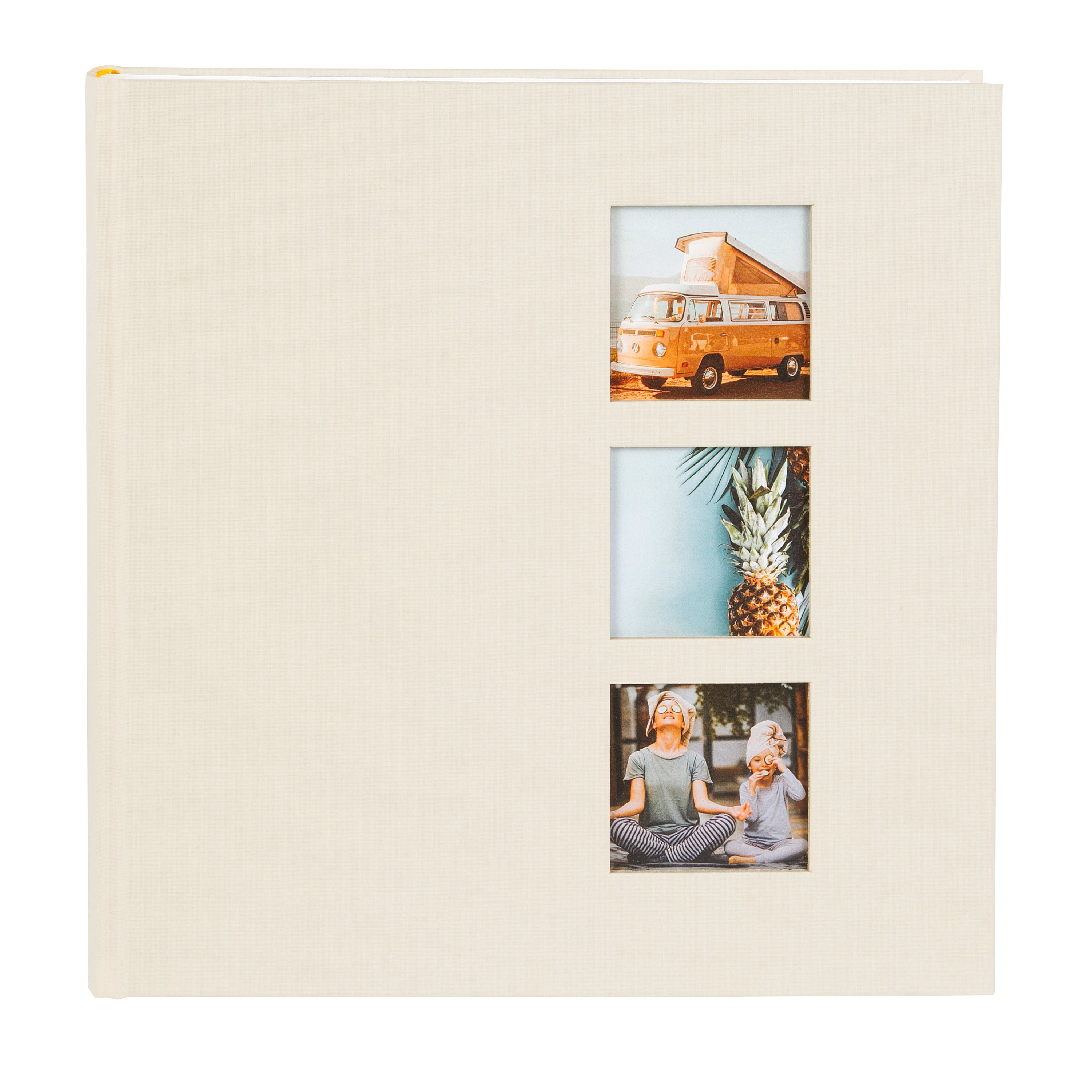 A Goldbuch photo album with three photographs showcased on its surface.