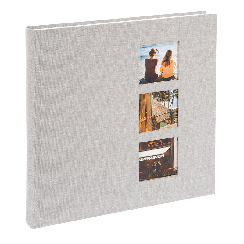 A grey Goldbuch photo album with three photographs showcased on its surface.