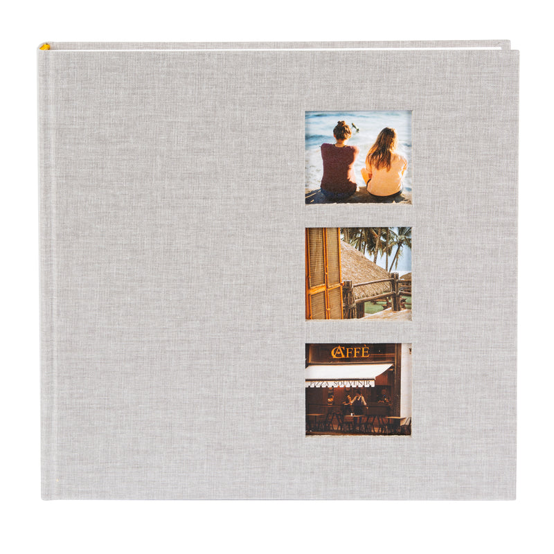 A grey Goldbuch photo album with three photographs showcased on its surface.