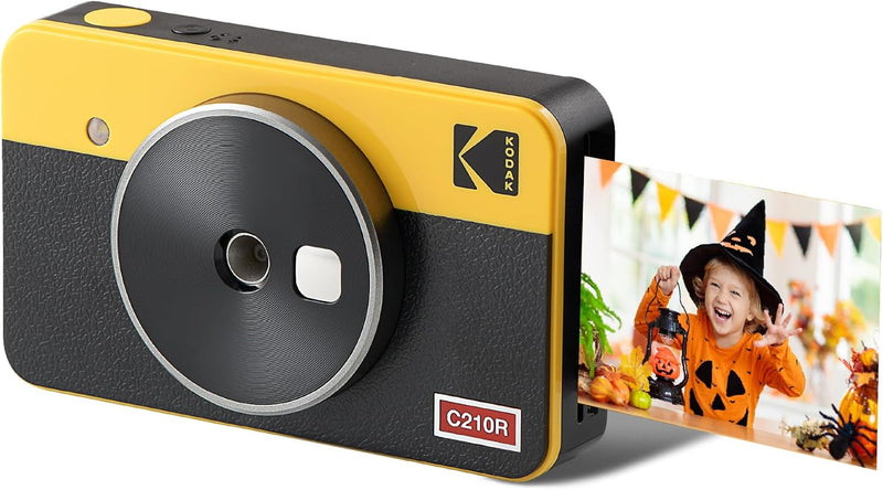 A yellow and black Kodak instant camera displaying a photo during the printing procedure.