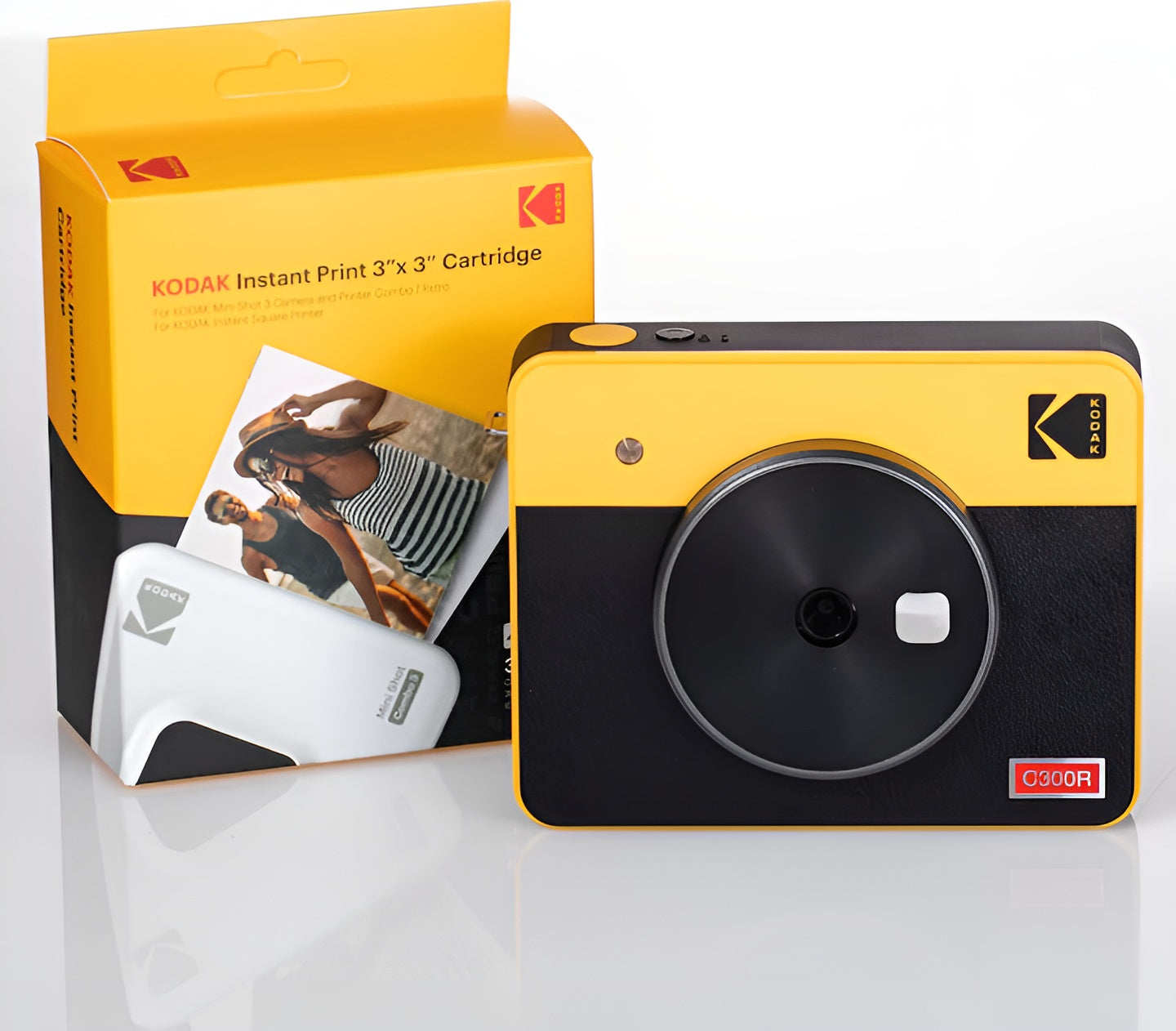 A yellow and black Kodak instant camera displaying a photo during the printing procedure.