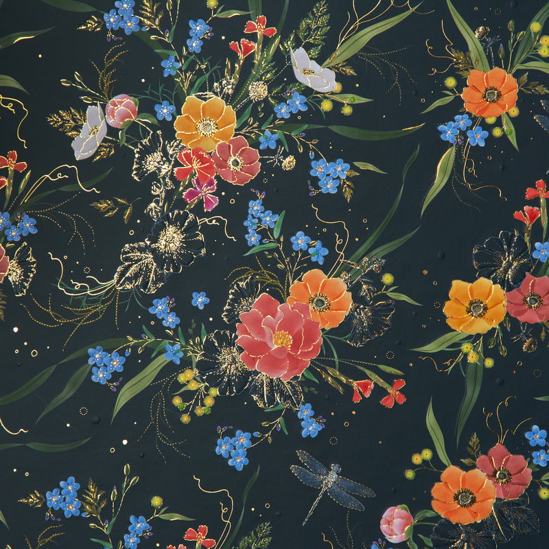 A Goldbuch photo album with a flower illustration on a dark cover, showcasing its hardcover design and white pages.