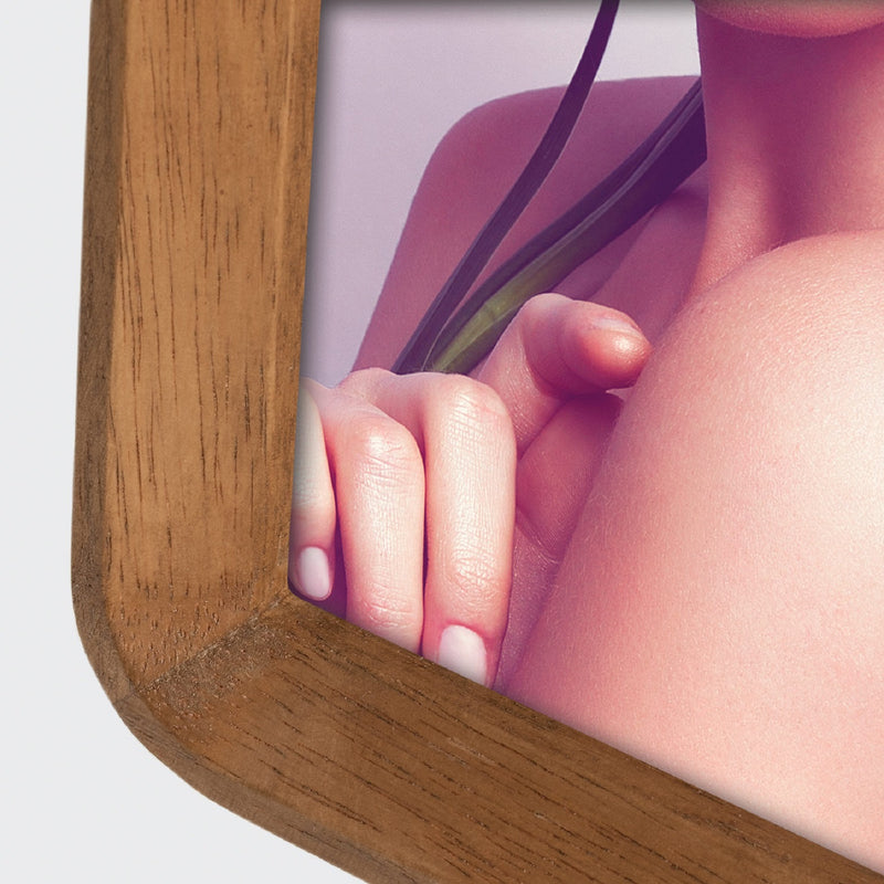 A ZEP wooden photo frame displaying a portrait of a woman, elegantly showcasing her image.