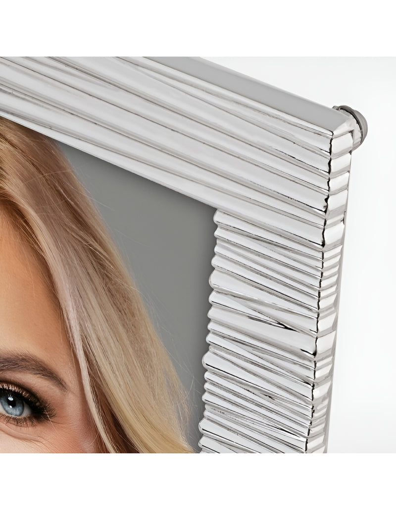 A smiling blonde woman displayed in a stylish white ZEP metal photo frame, radiating beauty and joy.