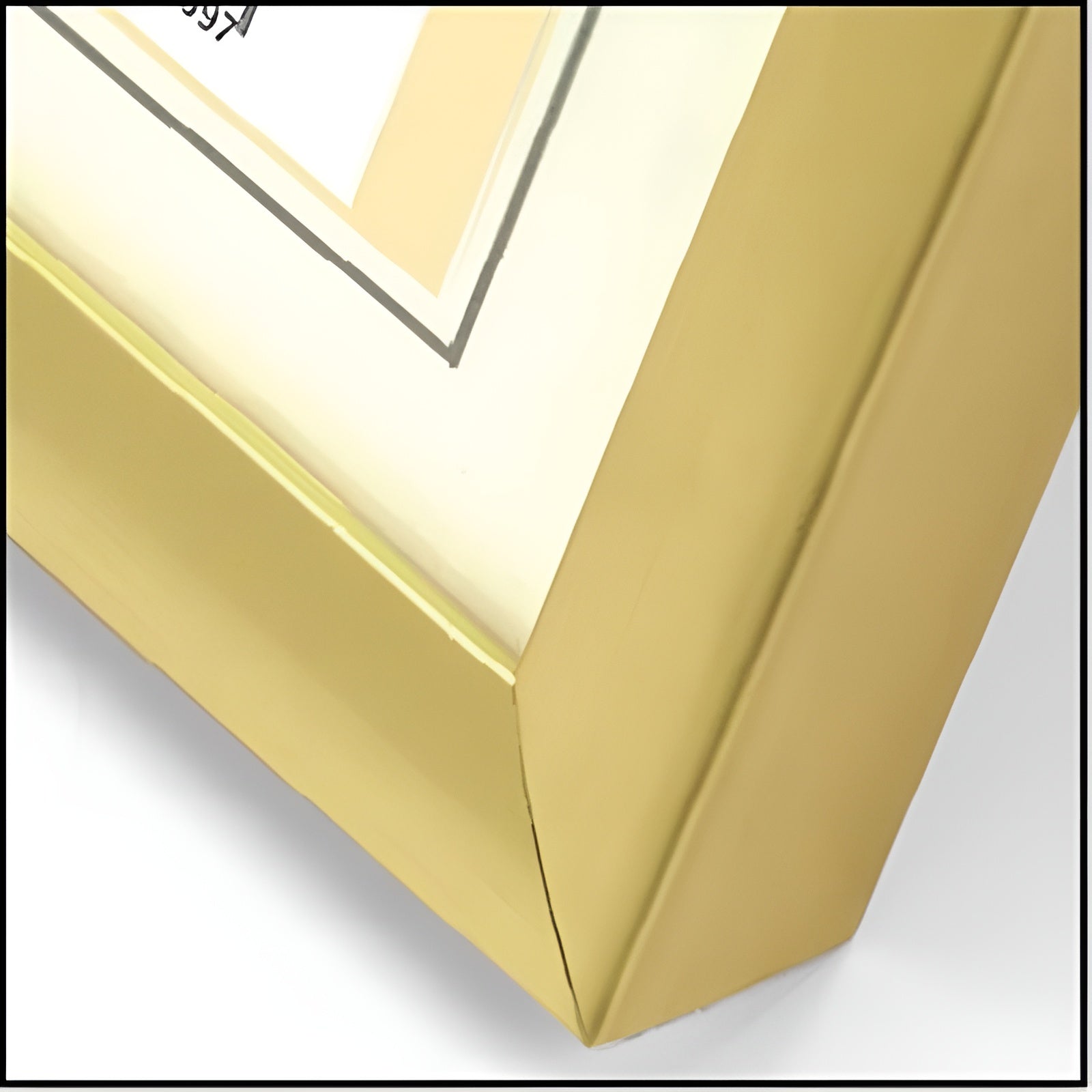 Close-up of a glossy gold ZEP picture frame corner with a cream mat and a white document insert.
