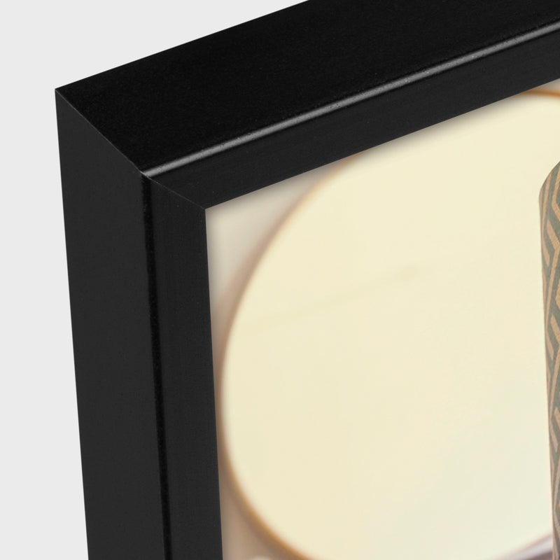 Close-up of a ZEP black framed picture with a light background